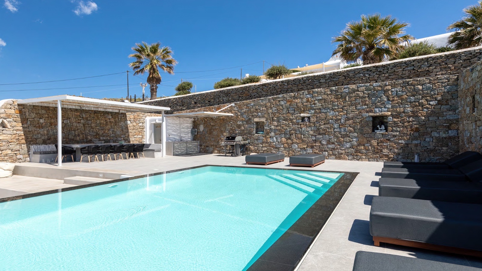 Mykonos pool patio with stone wall