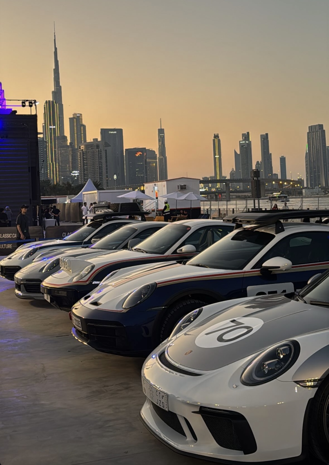 Porsche line-up with Burj Khalifa at sunset
