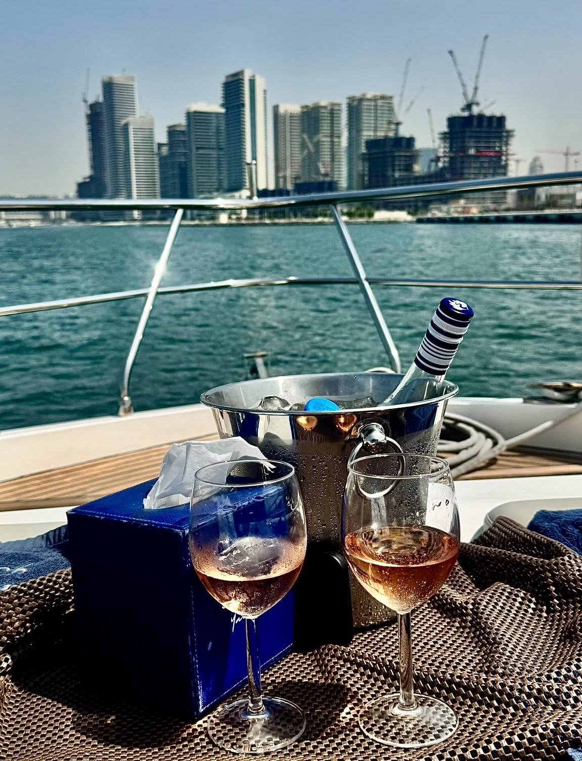 Yacht at anchor with city skyline