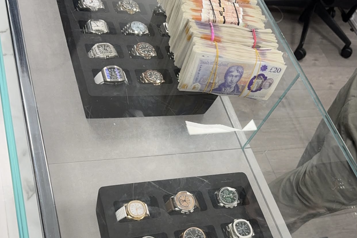 Luxury watch collection with cash