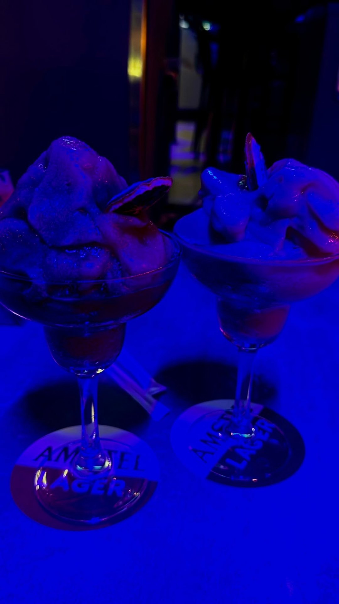 Cocktails under blue nightclub light